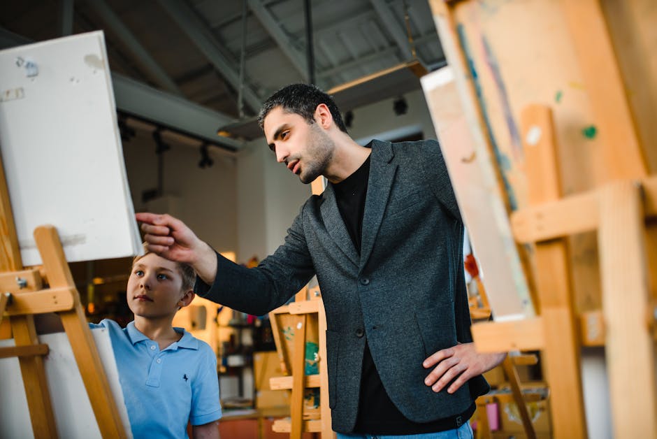 Art teacher instructing a young student in an art studio, focusing on painting techniques.