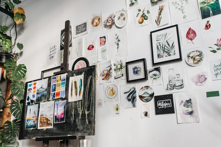 A wall filled with diverse watercolor artworks in a creative art studio setting.